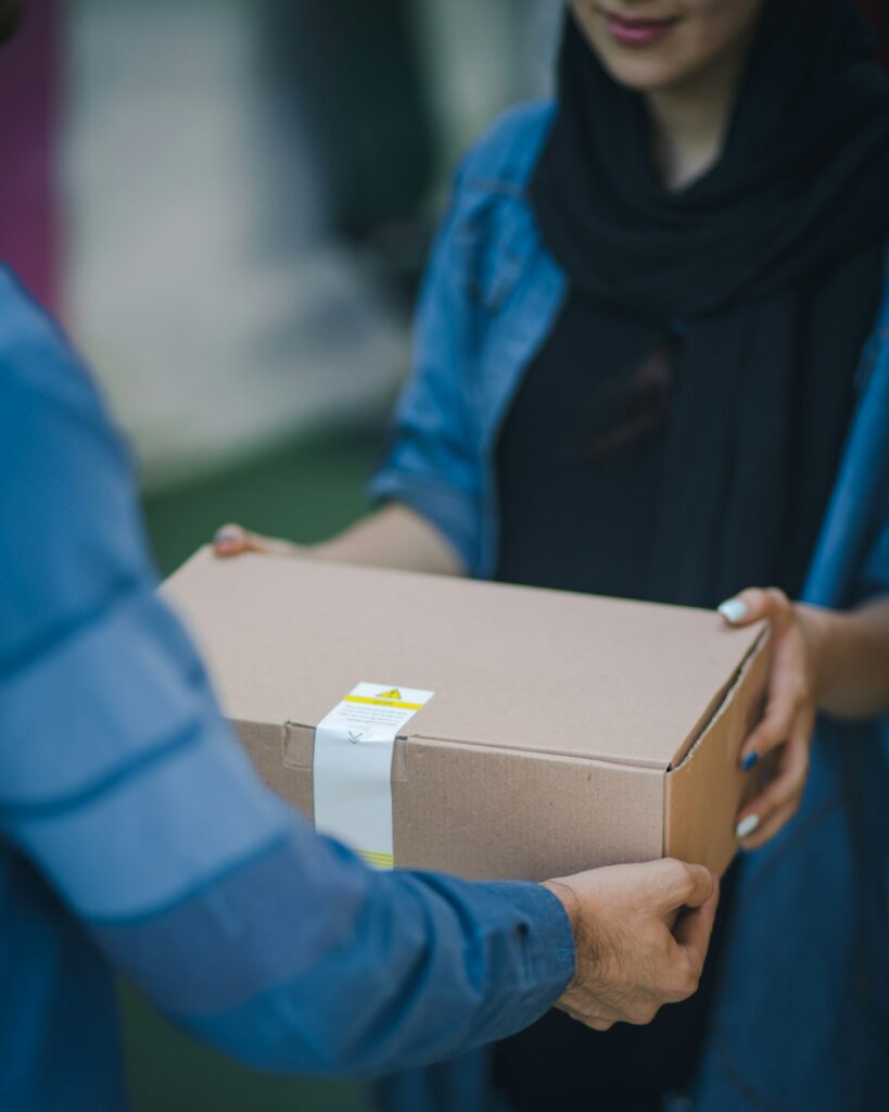 Courier handing over a Mega Sale delivery box